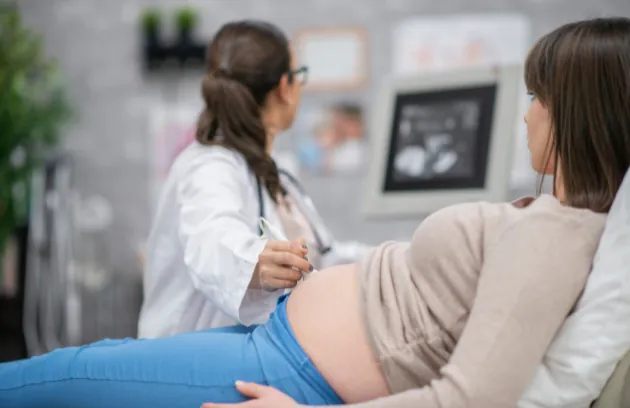 Obstetrician examining a pregnant woman